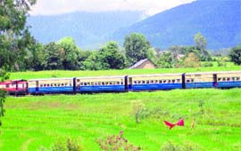 A train passes through the Kangra valley.