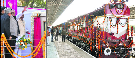 Union Minister of State for Railways KJ Surya Prakash Reddy and Haryana CM Bhupinder Singh Hooda wave to the crowd as the Rewari-Rohtak passenger train starts its maiden journey from Rewari on Tuesday. 