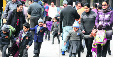 Small children brave the severe cold while going to their schools in Jalandhar on Tuesday. 