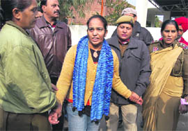 Policewomen take Jaswinder Kaur, resident of Malsiyan, who tried to commit suicide in front of the office of the Inspector-General of Police, in custody in Jalandhar on Tuesday. 