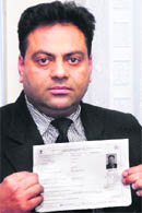 Lakhwinder Singh Arora shows his enrollment number for getting Aadhaar card prepared. 
