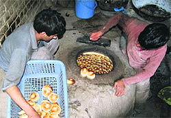 Bread makers prepare Kashmiri bread in Habbakadal downtown in Srinagar on Tuesday