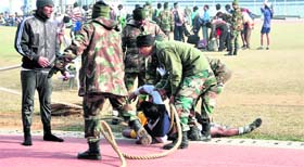 An aspirant falls on the track after he failed to complete the race during the recruitment rally in Ludhiana.