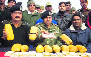 BSF personnel with the seized contraband in Ferozepur on Tuesday. 