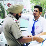 Traffic police official challans a student in Amritsar. 