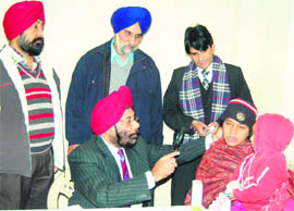 Dr AS Sachdev, District Leprosy Officer, examines patients during a leprosy screening camp at Ranjit Avenue Satellite Hospital in Amritsar on Wednesday. 