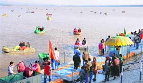 Visitors enjoy a sunny day at the Sukhna Lake in Chandigarh on Wednesday