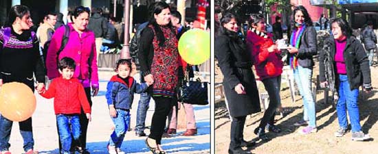 (Left) A family enjoys the weather at the Sector 17 Plaza in Chandigarh on Wednesday. Tribune photo: S. Chandan (right) Students share a light moment on the Panjab University campus in Chandigarh on Wednesday. Tribune photo: Parvesh Chauhan