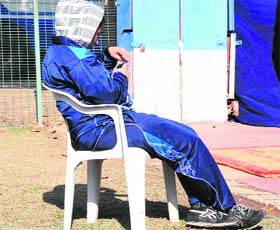 A BPEd student, appointed as a line official, uses a mobile phone during a tennis match at the PU in Chandigarh on Wednesday