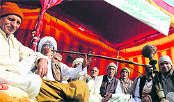 BKU activists stage a dharna outside a sugarmill in Karnal on Wednesday, seeking a hike in the support price for sugarcane