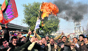 BJYM activists burn Pakistan national flag in Mendhar in Poonch district on Wednesday. 