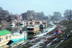 A view of snow accumulated on the banks of the Jhelum in Srinagar on Wednesday