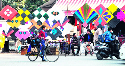 Two schoolchildren stop to take a look at a variety of kites being sold on a road in Amritsar on Thursday. The demand for kites sees an increase around Lohri. 