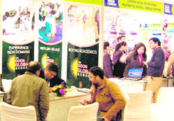 Parents take guidance at stalls of various schools during the Premiere School Exhibition in Amritsar on Thursday. 