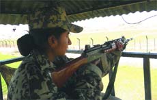 Braving the biting cold, a woman BSF constable keeps vigil along the Indo-Pak border.