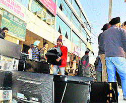 A worker removes goods from a showroom at Shahi Majra village in Mohali on Thursday