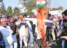 BKU activists burn an effigy of the Haryana government outside a sugarmill in Karnal on Thursday, seeking a higher support price for sugarcane.
