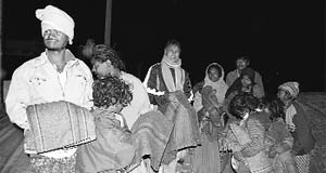 Poor people found sleeping in the open at Sannihit Sarovar in Kurukshetra get blankets from team Jindal on a cold Wednesday night. 