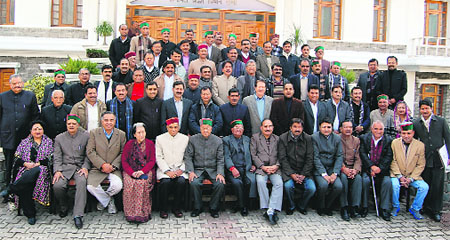 Members pose for photographers in front of the Vidhan Sabha in Dharamsala on Thursday. 