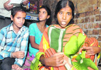 A cancer patient, Rani, with her children in Jalandhar. Tribune photo: Malkiat Singh