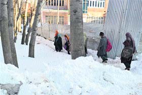 White-out: Children of Damhall, Hanjipora, in Kulgam district walk in the snow to attend tuition during winter vacations in the Kashmir valley on Thursday