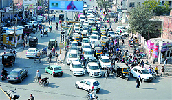 There is a long queue of vehicles at Hanuman chowk during the peak hours with traffic coming in from four directions