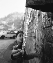 A child touches icicles in Shimla on Friday. 