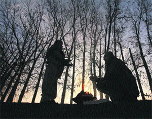 Men sit around a bonfire to keep themselves warm in Jammu on Friday.  