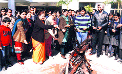 Teachers and students of Seth Hukam Chand SD Public Senior Secondary School celebrate Lohri in Jalandhar on Friday