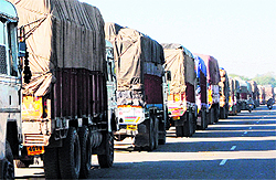 Trucks wait to cross over to Pakistan at Attari on Friday. Around 100 trucks carrying dry dates, gypsum, limestone and dry fruits are arriving from Pakistan through Attari. India is also exporting over 250 truckloads of various goods daily