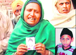 The mother of Nishan Singh (inset) wails holding his picture in Amritsar on Saturday. photo: vishal kumar
