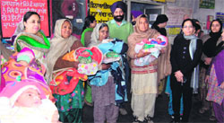 Senior Medical Officer Balbir Singh Dhillon along with staff celebrate Lohri with newborn girls at the Civil Hospital in Amritsar on Saturday. photo: Sameer Sehgal 