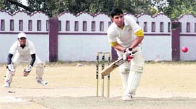 A batsman plays a defensive shot in a match during the 61st Dehradun District Cricket League in Dehradun on Saturday.
