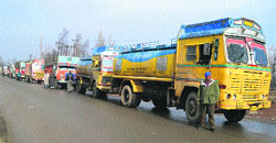 Trucks stranded near Qazigund in Anantnag district after the Jammu-Srinagar National Highway was closed to traffic due to snowfall on Saturday. Tribune photo: Amin War