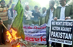 Activists of Real Cause, an NGO, burn an effigy of Pakistan during a demonstration against the brutal killings of two Indian soldiers by the Pakistan army, at Jantar Mantar in New Delhi on Sunday