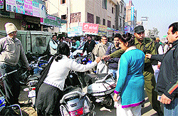 SSP Raj Shri Singh (second from right) checks documents of vehicles near Laal Batti Chowk in Sirsa