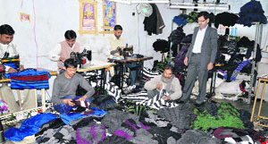 Workers busy finishing orders in a hosiery unit in Ludhiana.
