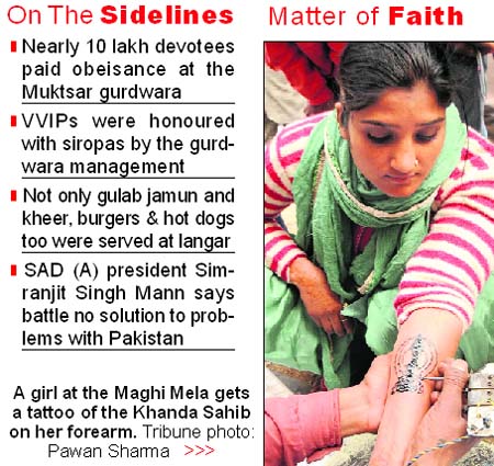 A girl at the Maghi Mela gets a tattoo of the Khanda Sahib on her forearm