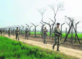 BSF jawans patrol along the Indo-Pak border fence, 27 km from Wagah, on Sunday