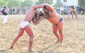 A wrestling bout in progress at Phase VIII, Mohali, on Monday