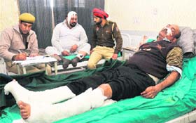 The injured policeman and accused at a hospital in Mohali on Monday