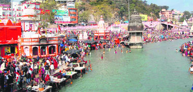 Devotees take a holy dip in the Ganga on Makar Sankranti at Braham Kund, Har-ki-Pauri, in Haridwar on Monday.