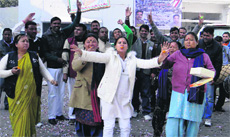 Congress workers celebrate the laying of the foundation stone of the new Assembly building at Gairsain at the Congress bhavan in Dehradun on Monday.