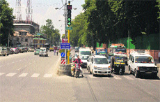 Vehicles wait for a green signal in Srinagar on Monday.