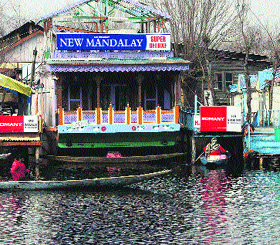 A man rows a shikara on the Dal Lake in Srinagar on Monday. 
