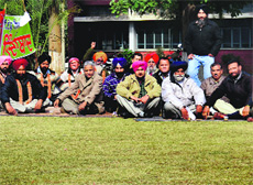 PAU employees hold a protest outside Thapar Hall in Ludhiana.