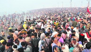 Hindu devotees gather early morning at Sangam, the confluence of the Ganges, the Yamuna and the mythical Saraswati, on Makar Sankranti, marking the beginning of the Mahakumbh Mela in Allahabad on Monday.