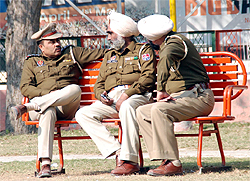 Policemen enjoy bright sunshine in a park in Bathinda on Tuesday