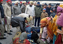 Police pesonnel rummage through the luggage of some passengers at the Bathinda railway junction during a combing operation launched on Tuesday