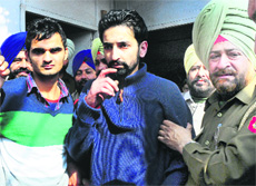 The accused in police custody; and (right) a policeman shows the bullet mark at the Sector 50/51 roundabout in Chandigarh on Tuesday. 